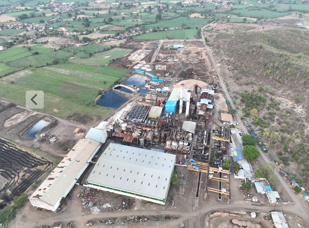 Aerial view of the mill at Bachai, white roofs among green cane fields